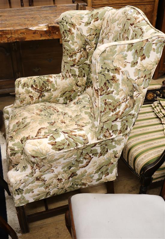 A Georgian style wing armchair with floral upholstery
